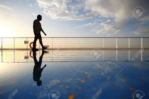 12511493-silhouette-of-old-man-walking-throught-deck-of-cruise-ship-morning-golden-sun-shining-reflection-in-
