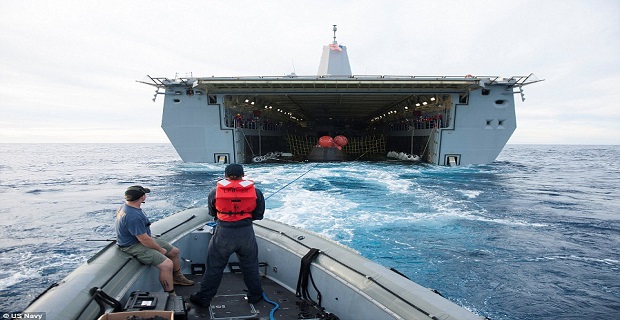23e2852a00000578-0-recovery_team_members_in_a_zodiac_boat_help_guide_nasa_s_orion_s-a-51_1418064245842