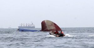 An Indonesia rescue team approaches the sunken Antigua and Barbuda flagged freighter MV Thorco Cloud which sank after colliding with a tanker the night before, in the Singapore Strait off the Indonesian island of Batam