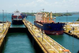 Two cargo ships enter the Gatun Locks from the Gatun Lake