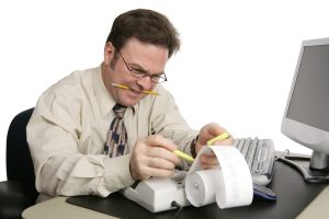 An accountant preparing someone's income taxes. Isolated on white.