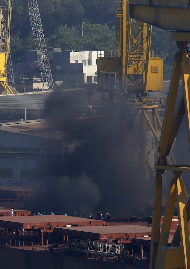 Thick black smoke rises from the deck of the Liberia-registered bulk carrier Cape Tavor at the Palumbo dockyard in Valletta's Grand Harbour