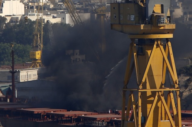 Thick black smoke rises from the deck of the Liberia-registered bulk carrier Cape Tavor at the Palumbo dockyard in Valletta's Grand Harbour