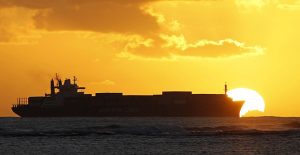 A cargo ship cruises as the sun sets at Ala Moana beach ahead of the APEC meeting in Honolulu