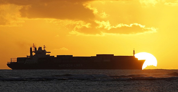 A cargo ship cruises as the sun sets at Ala Moana beach ahead of the APEC meeting in Honolulu