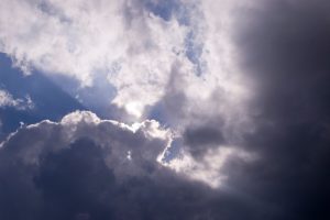 stormy looking clouds and beam sunlight with blue sky