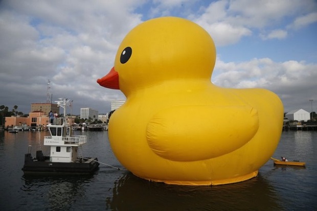 Giant inflatable rubber duck installation by Dutch artist Florentijn Hofman floats through the Port of Los Angeles as part of the Tall Ships Festival, in San Pedro