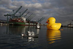 Giant inflatable rubber duck installation by Dutch artist Florentijn Hofman floats through the Port of Los Angeles as part of the Tall Ships Festival, in San Pedro