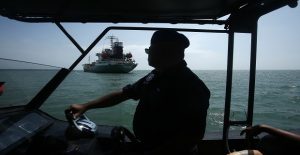 A maritime police approaches the Japanese oil tanker which was raided by armed pirates at Port Klang