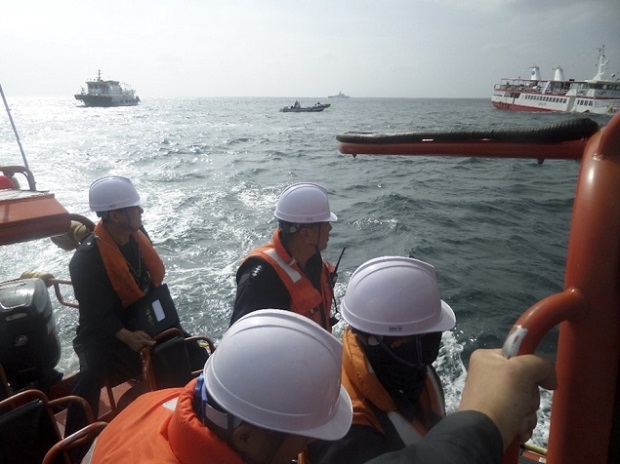 South Korean coast guards take part in the rescue of a sightseeing ship near the island of Hong-do, off the southwest coast