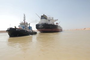 A tugboat works to refloat the Oil Products Tanker BURRI after it collided with LNG Tanker BW Lesmes in Suez Canal