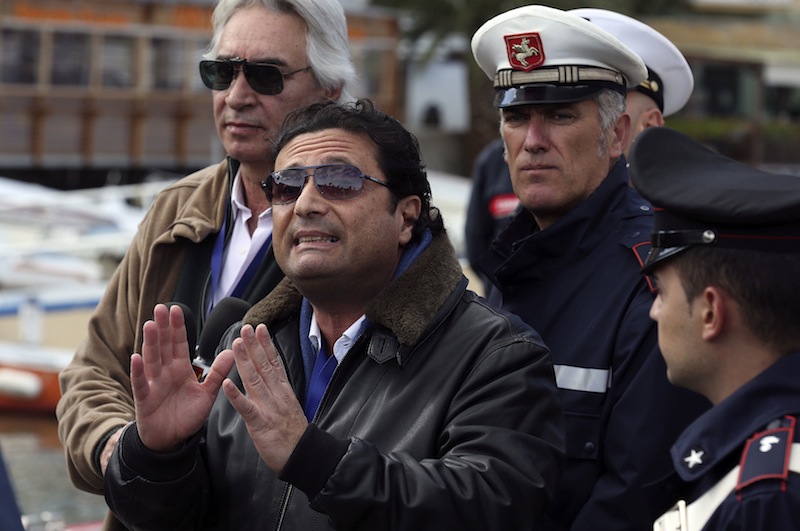 Schettino, the captain of the Costa Concordia, speaks to reporters after going back on board the cruise liner at Giglio harbour