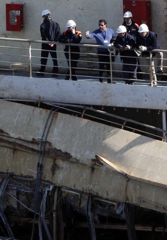 The captain of the Costa Concordia, Francesco Schettino, gestures as he stands onboard the Costa Concordia cruise liner at the Giglio harbour
