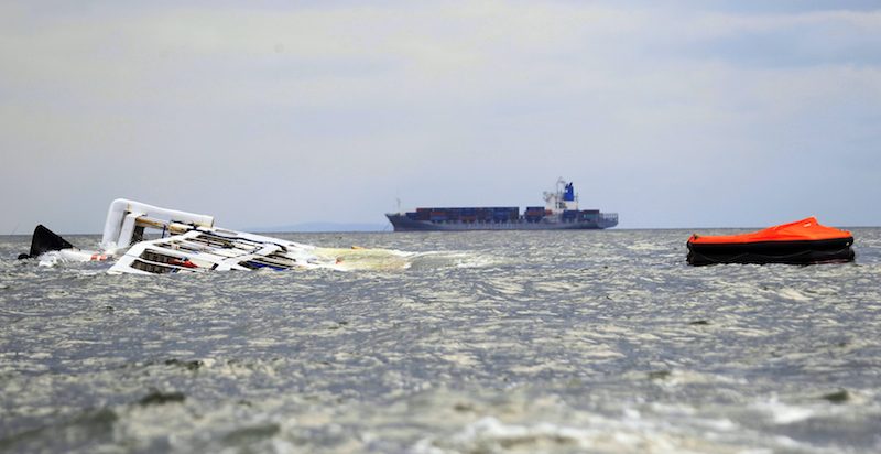 The Super Shuttle Ferry 7 floats on its side after it capsized in strong winds and huge waves unleashed by Typhoon Kalmaegi, locally named Luis, in Manila Bay